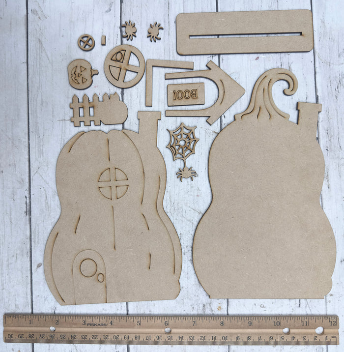 Unassembled Haunted Pumpkin House DIY Kit pieces shown with a ruler for size reference