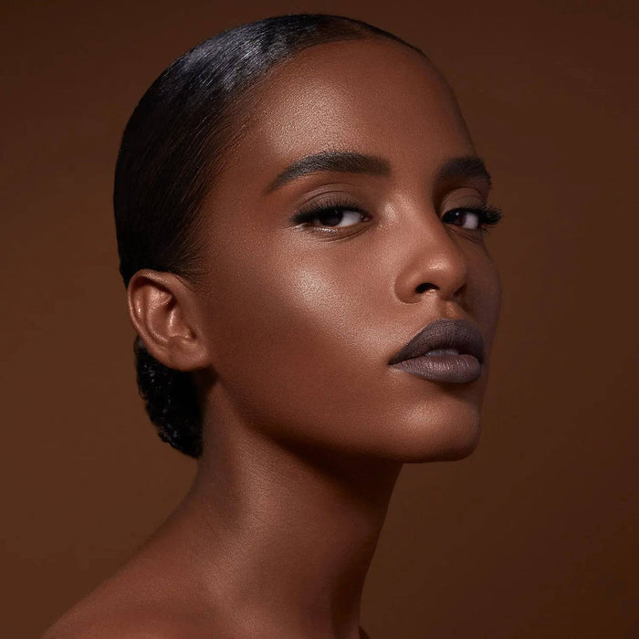 Mini Bronze and Glow Cheek Palette model look on a brown background.