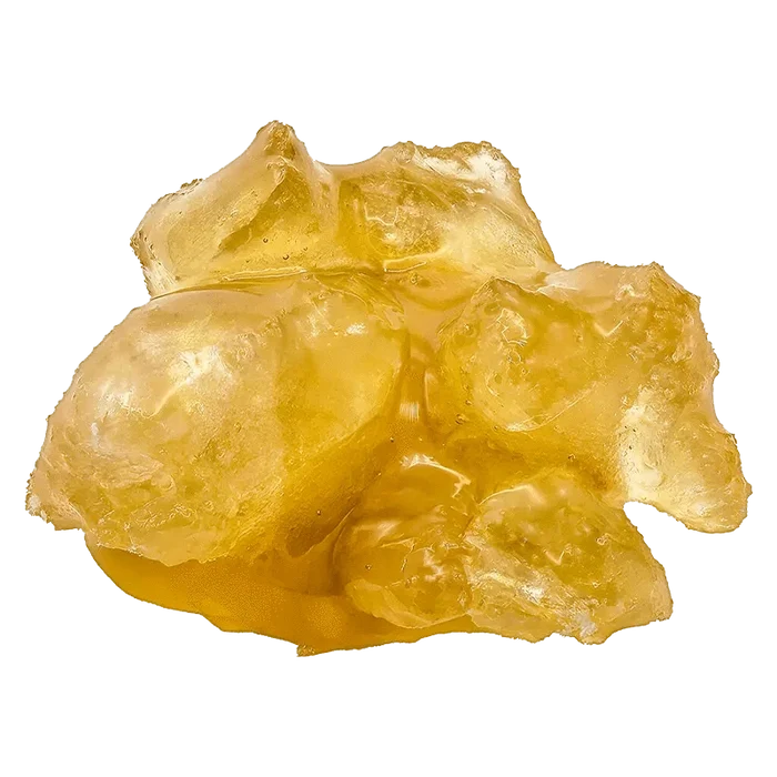 A close-up shot of the translucent, golden Alien Godfather Diamonds n' Sauce with a textured, crystalline structure against a plain white backdrop.