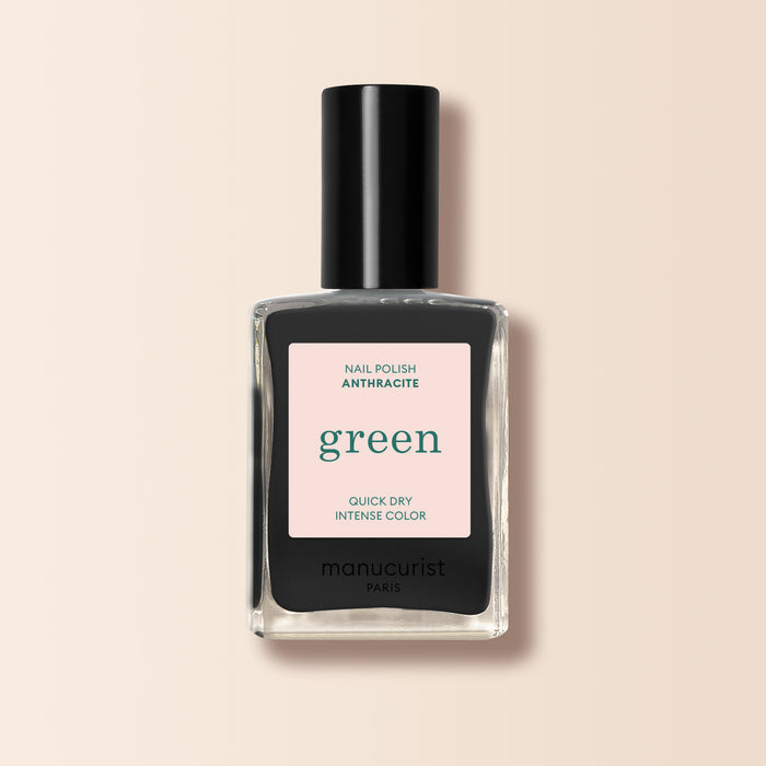 Manucurist Anthracite is a dark grey nail polish with a black cap and a label reading "green," "quick dry," and "intense color" on beige. Enjoy bold, lasting color from this eco-friendly shade.