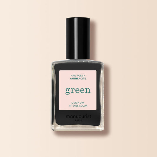 Manucurist Anthracite is a dark grey nail polish with a black cap and a label reading "green," "quick dry," and "intense color" on beige. Enjoy bold, lasting color from this eco-friendly shade.
