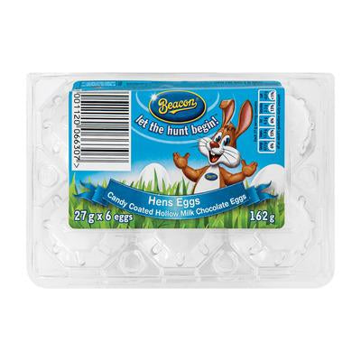 Six white candy coated chocolate eggs in a clear plastic carton with a blue Beacon Hens Eggs 162g label.