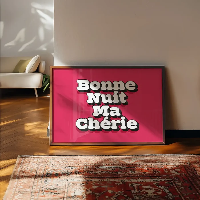 Bonne Nuit Ma Cherie Typography Quote Print framed, leaning on a wooden floor beside a rug