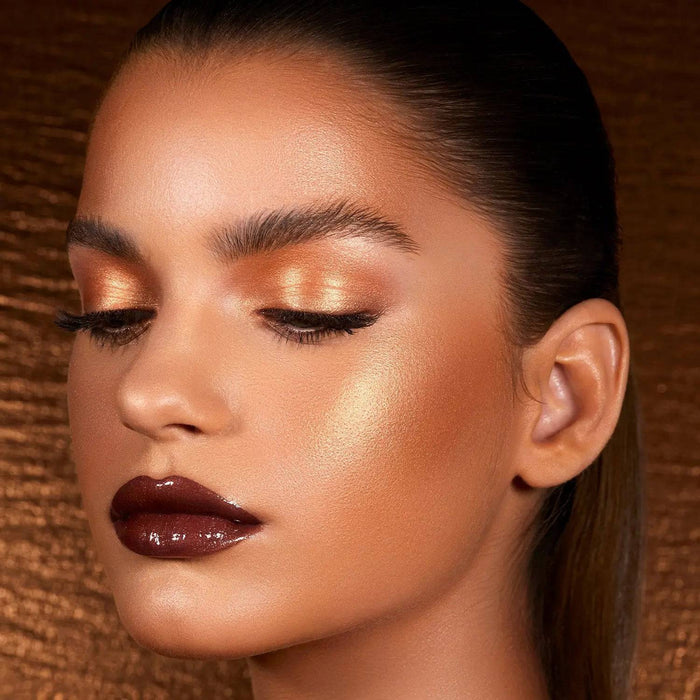 Bronze Cheek Palette model look on a shiny bronze background.