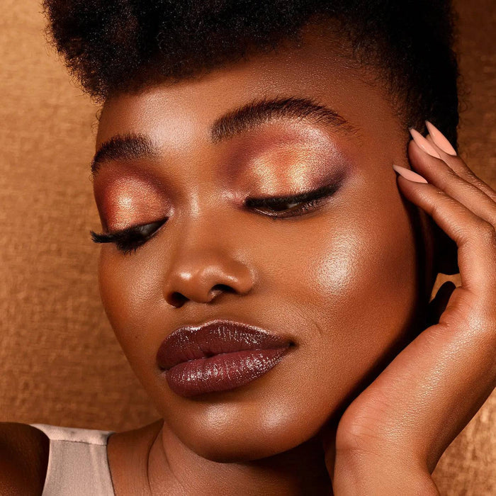 Bronze Cheek Palette model look on a shiny bronze background.