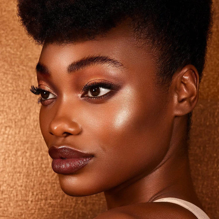 Bronze Cheek Palette model look on a shiny bronze background.