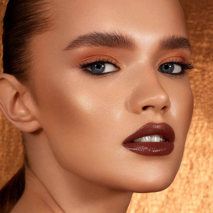 Bronze Cheek Palette model look on a shiny bronze background.