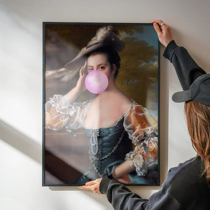 Bubblegum Lady Portrait Print being hung on a wall in a black frame