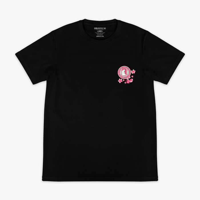 Front of black BL101 tee with a pink cherry blossom BL101 seal logo on the left chest, flat lay view