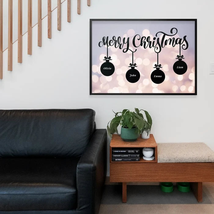 Framed Merry Christmas print featuring four personalized black baubles hanging over a blurred festive light background.