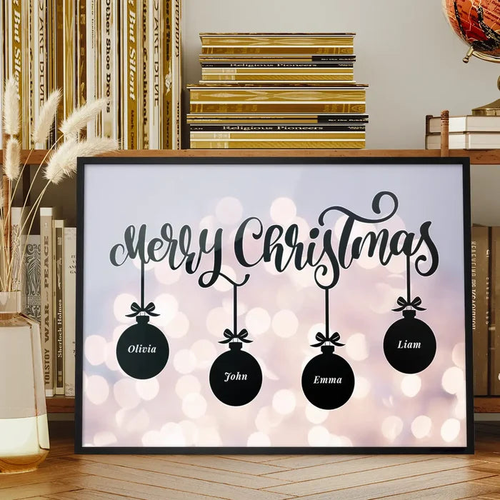 Personalized Merry Christmas print in a black frame featuring four black baubles with names against a bokeh light background.