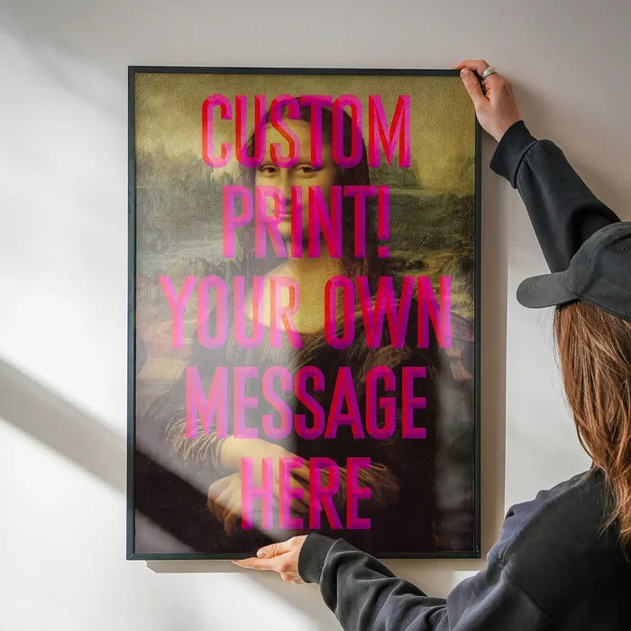 Custom Mona Lisa Quote Print being hung on a wall in a black frame