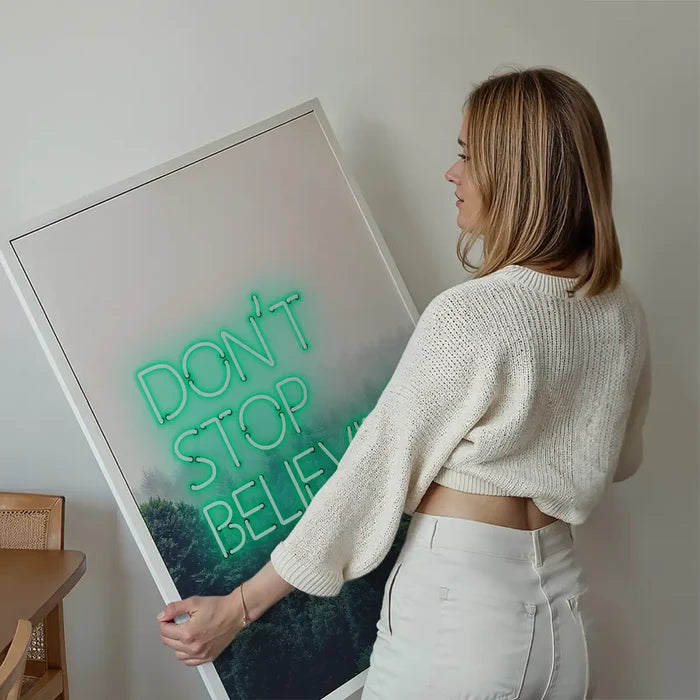 Dont Stop Believing Lyrics Neon Print held up against a living room wall