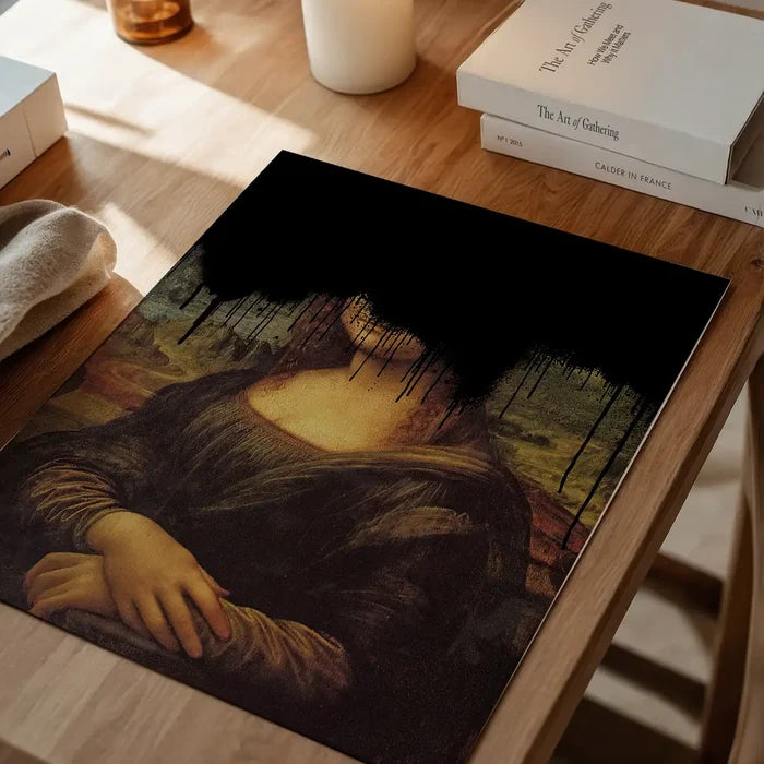 Drippy Mona Lisa Black Graffiti Print, quirky altered art print unframed on a home office desk