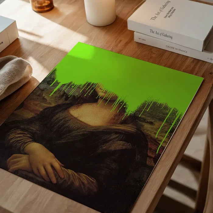 Drippy Mona Lisa Graffiti Print, quirky altered art print unframed on a home office desk