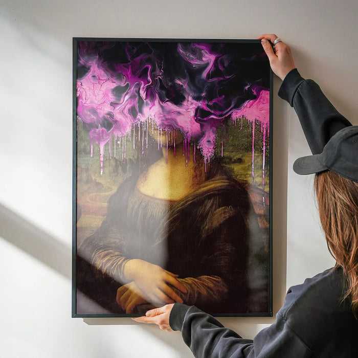 Drippy Mona Lisa Pink Gloop Print being hung on a wall in a black frame