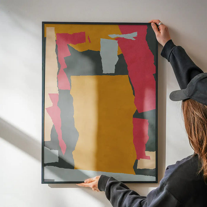Earth Paper Collage 1 Print being hung on a wall in a black frame