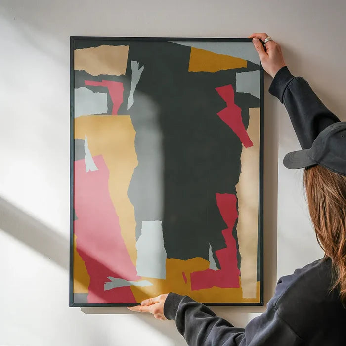 Earth Paper Collage 2 Print being hung on a wall in a black frame