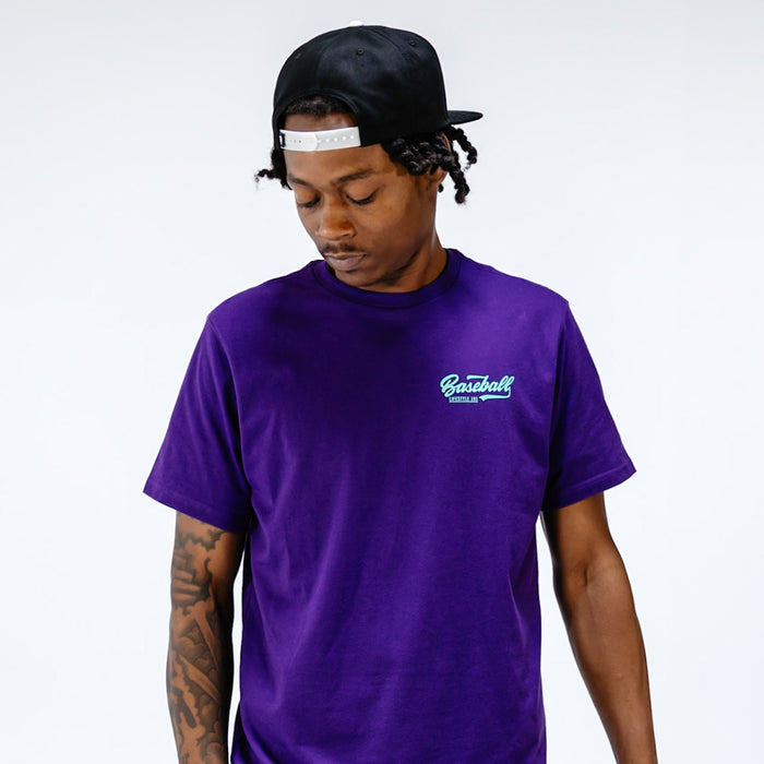 Adult model wearing purple and teal Established graphic tee