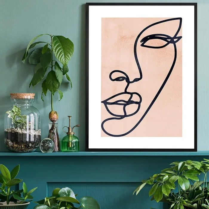Face Study Line Art Watercolour Print black framed on a living room shelf