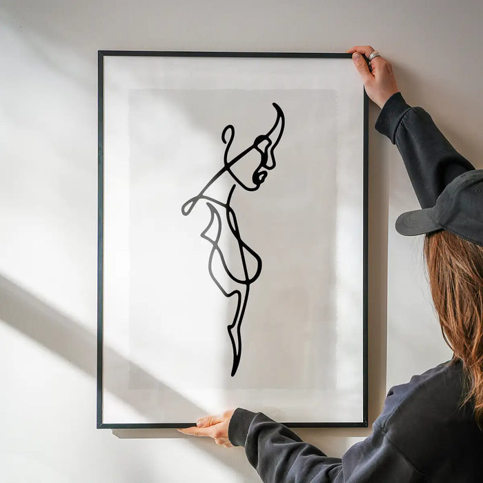 Female Side Study Line Art Print being hung on a wall in a black frame