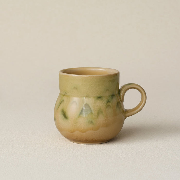 Hand-thrown ceramic mug by Rookwood Pottery