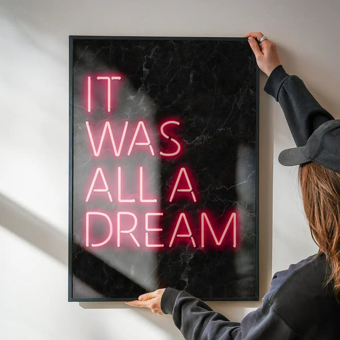 It Was All A Dream Neon Print being hung on a wall in a black frame