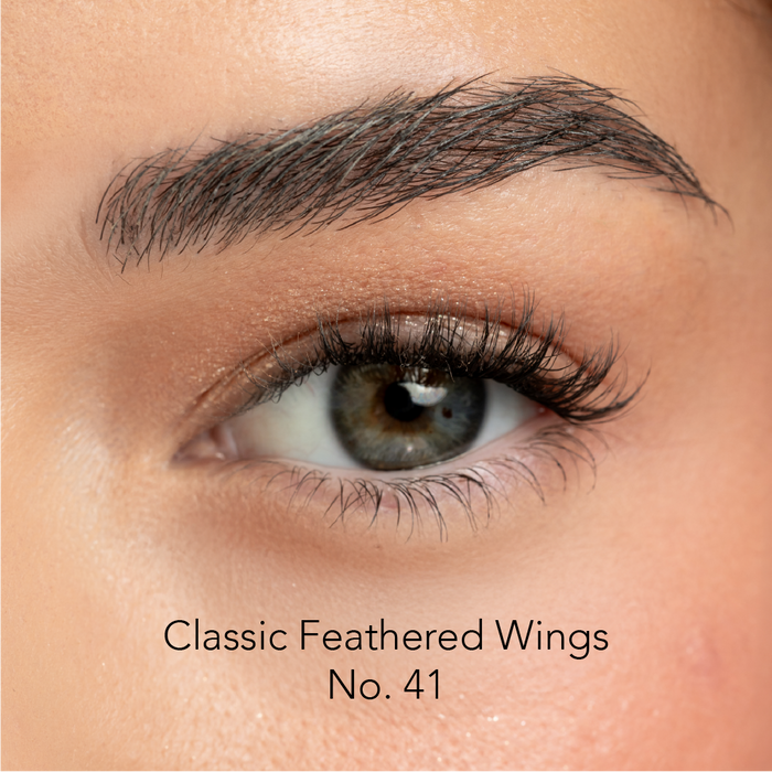 Close-up of an eye with false eyelashes labeled 'Classic Feathered Wings No. 41'.