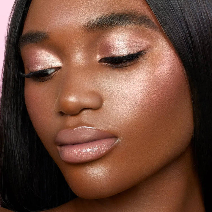 Love Glow Cheek Palette model look on a pink background.