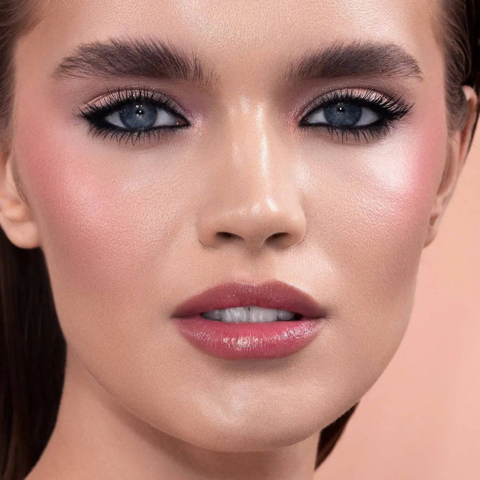 Mini Bloom Cheek Palette model look on a light pink background.