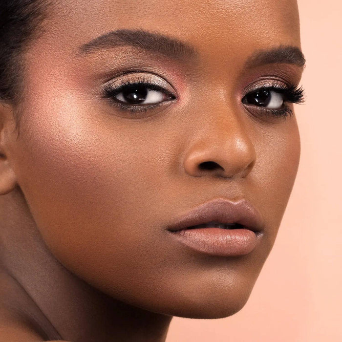 Mini Bloom Cheek Palette model look on a light pink background.