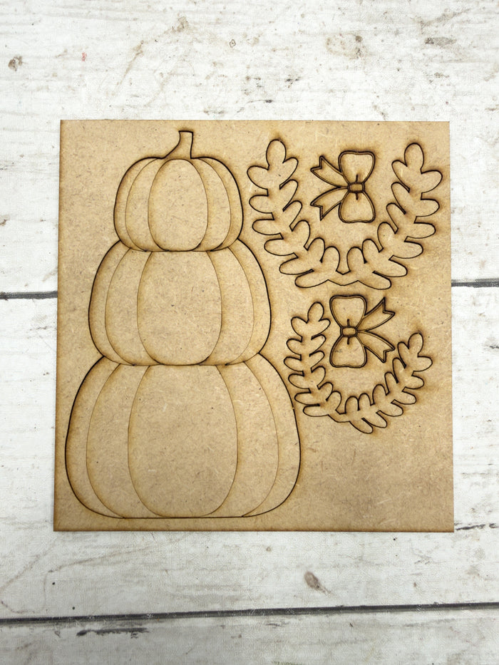 Unfinished laser-cut wood pieces included with the mini stacked pumpkin DIY kit