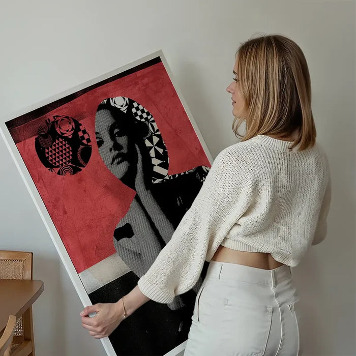 Woman holding a large Model 1 pink graphic art print featuring a stylized portrait on thick archival paper.