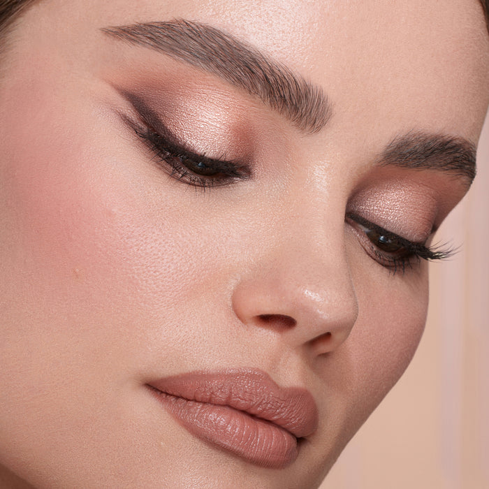 My Mini Dream Glow Blush Ornament model look on a pink background.