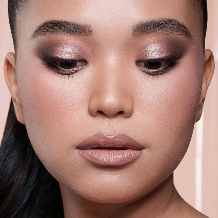 My Mini Dream Glow Blush Ornament model look on a pink background.