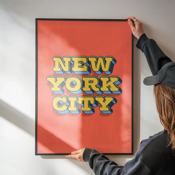 New York City Typography Print being hung on a wall in a black frame