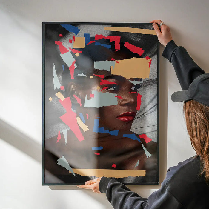 Paper Portrait Print being hung on a wall in a black frame