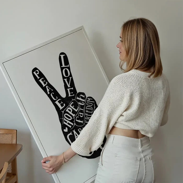 Peace Fingers Typography Print held up against a living room wall