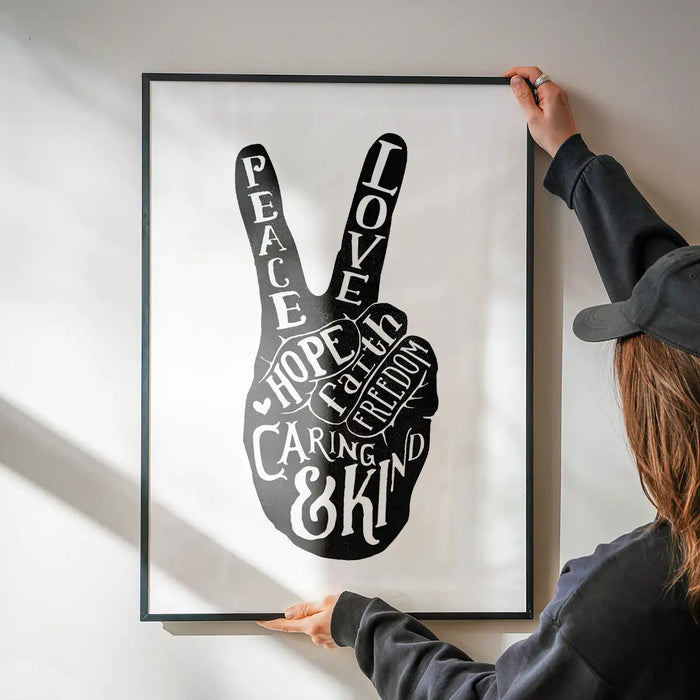 Peace Fingers Typography Print being hung on a wall in a black frame