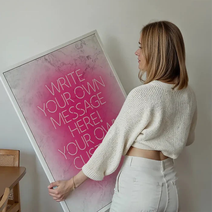 Pink Neon Centered White Print held up against a living room wall