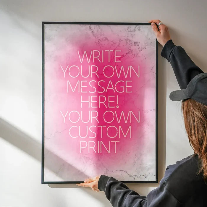 Pink Neon Centered White Print being hung on a wall in a black frame