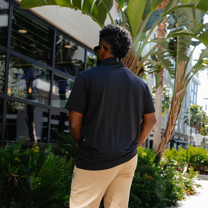 Adult model wearing black Pro Series Elite polo