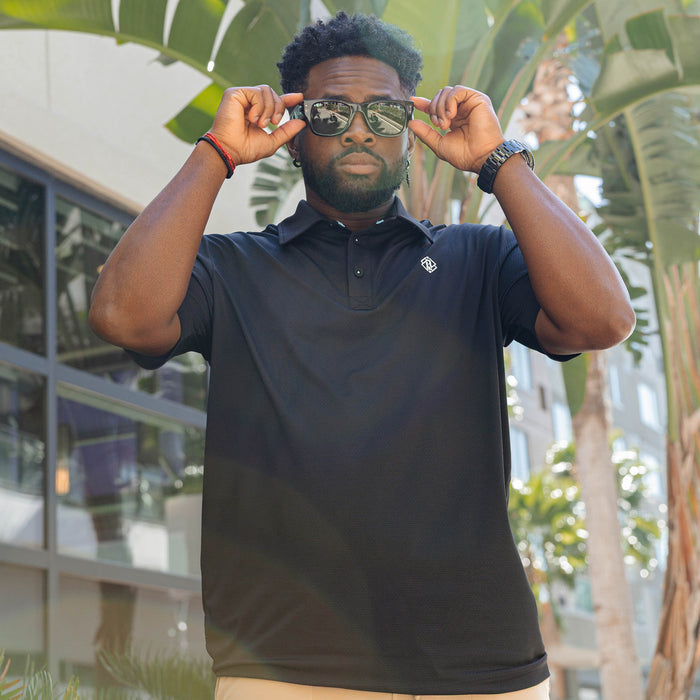 Adult model wearing black Pro Series Elite polo