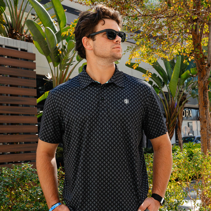 Adult model wearing black and gray Pro Series Elite polo