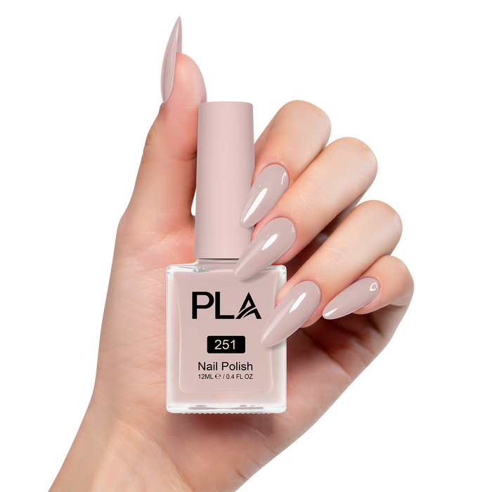 Hand holding a bottle of PLA nail polish with matching nails on a white background