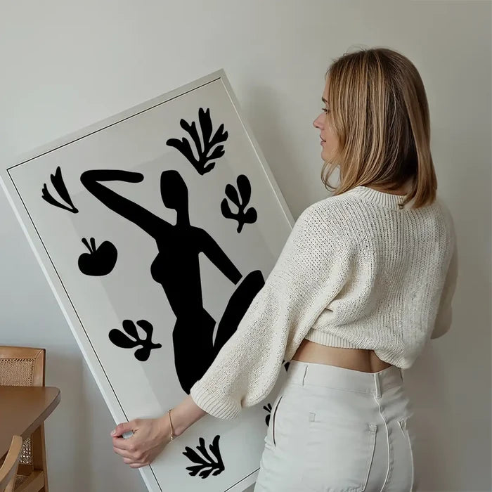 Sitting Woman Black and White Painting Print held up against a living room wall