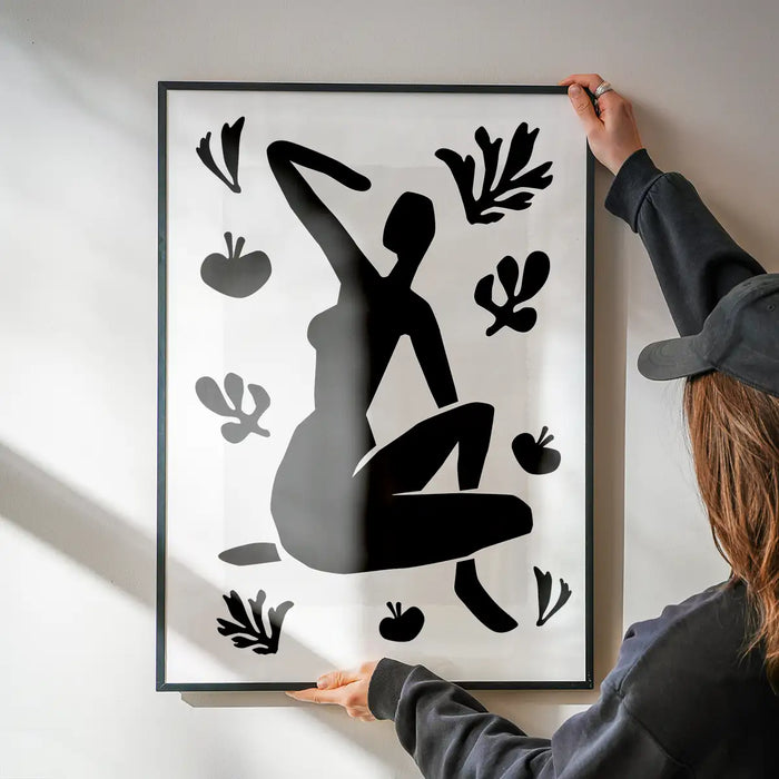 Sitting Woman Black and White Painting Print being hung on a wall in a black frame