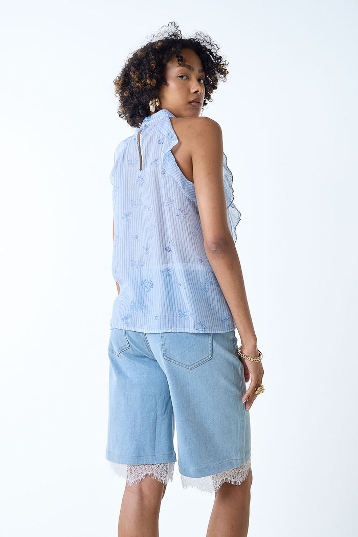 Textured ruffle front sleeveless high neck blouse wholesale