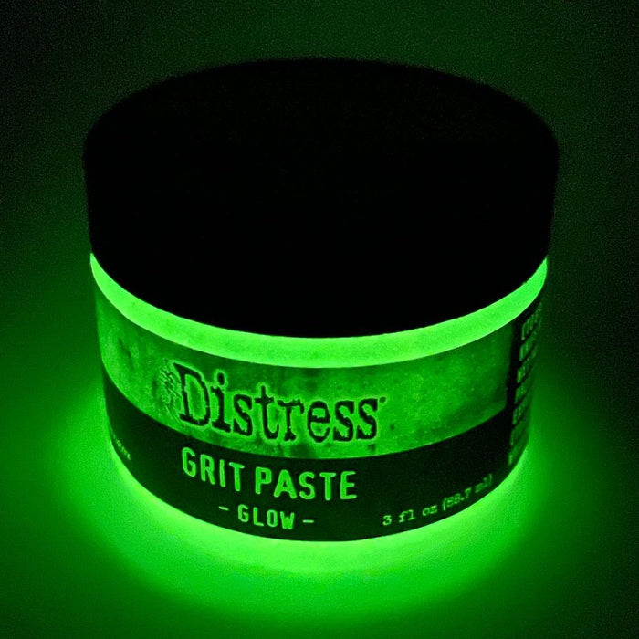 Tim Holtz - Distress Grit Paste - 3oz - Glow. Tim Holtz Distress Mixed Media Medium Grit Paste - Glow is a texture paste that glows in the dark when exposed to the sun or UV light. It adds a glow effect to spooky projects of all kinds. Available at Embellish Away located in Bowmanville Ontario Canada.