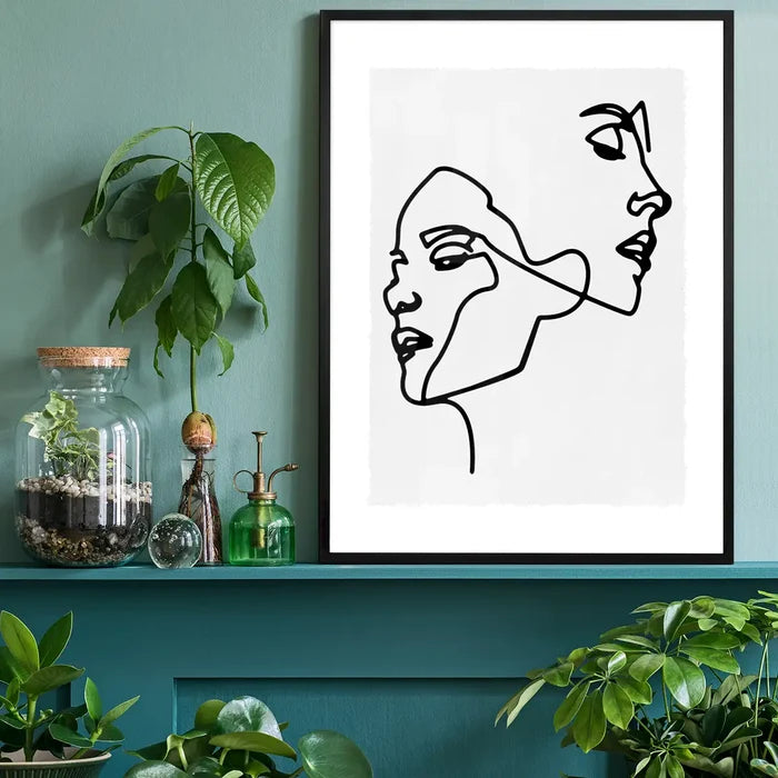 Two Faces Study Line Art Print black framed on a living room shelf